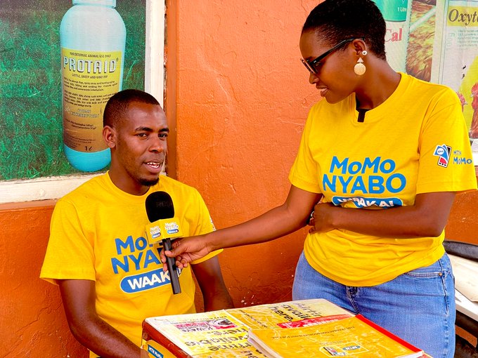Rogers Karamuzi l an MTNMoMo agent along High street in Mbarara speaks to Haffi Powersr a presenter of the MTN MoMo Nyabo promotion about how he feels having won 100000shs from MTN