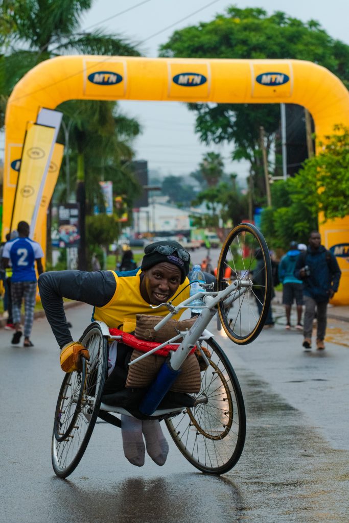 Overall winner of the MTN Kampala Marathon 2022 wheelchair race Richard Ocira celebrates after crossing the finish line 1