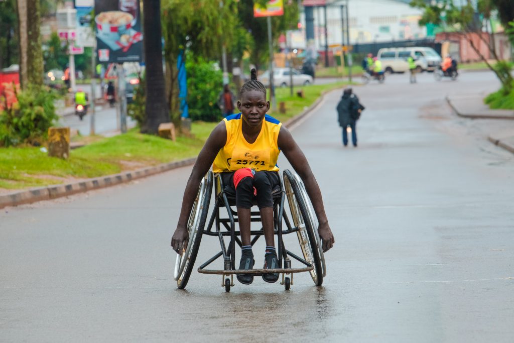 Womes category winner of the MTN Kampala Marathon 2022 wheelchair race approaches the finish line