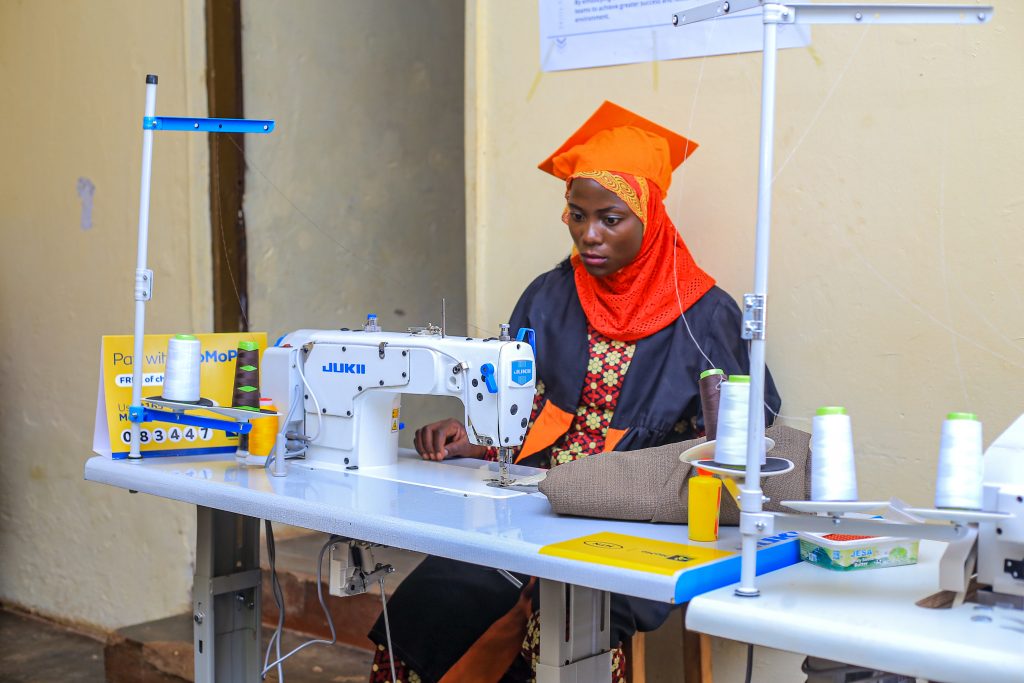 A learner at Heta Vocational Grounds tries the MTNs newly donated tailoring machines on March.15